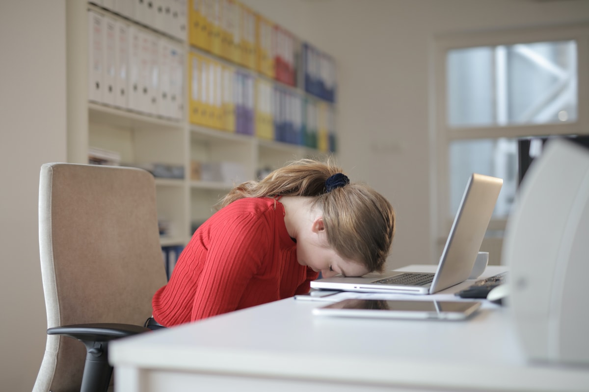 frustrated woman sitting in ergonomic office chair