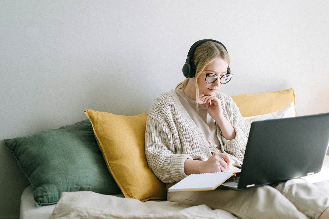 woman working with laptop on couch