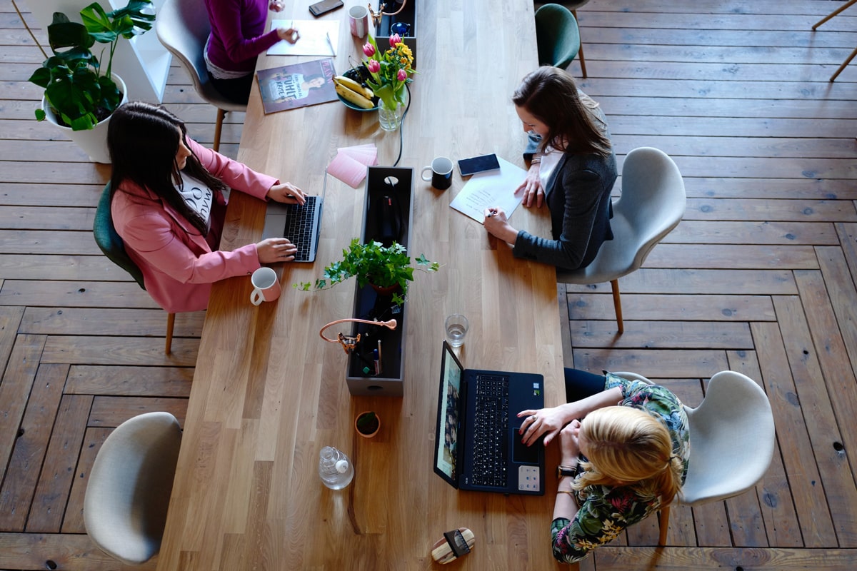 three people working at a desk