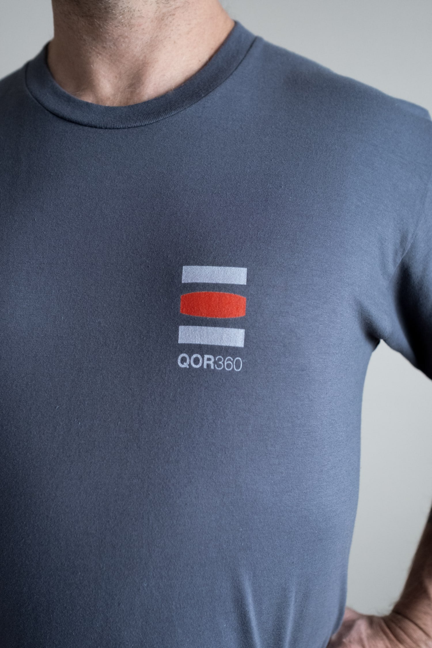 man wearing "give a sit" t-shirt qor360 logo