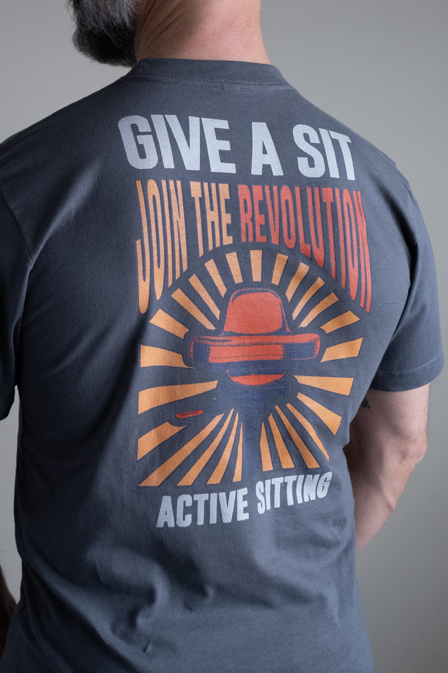 man wearing "give a sit" t-shirt