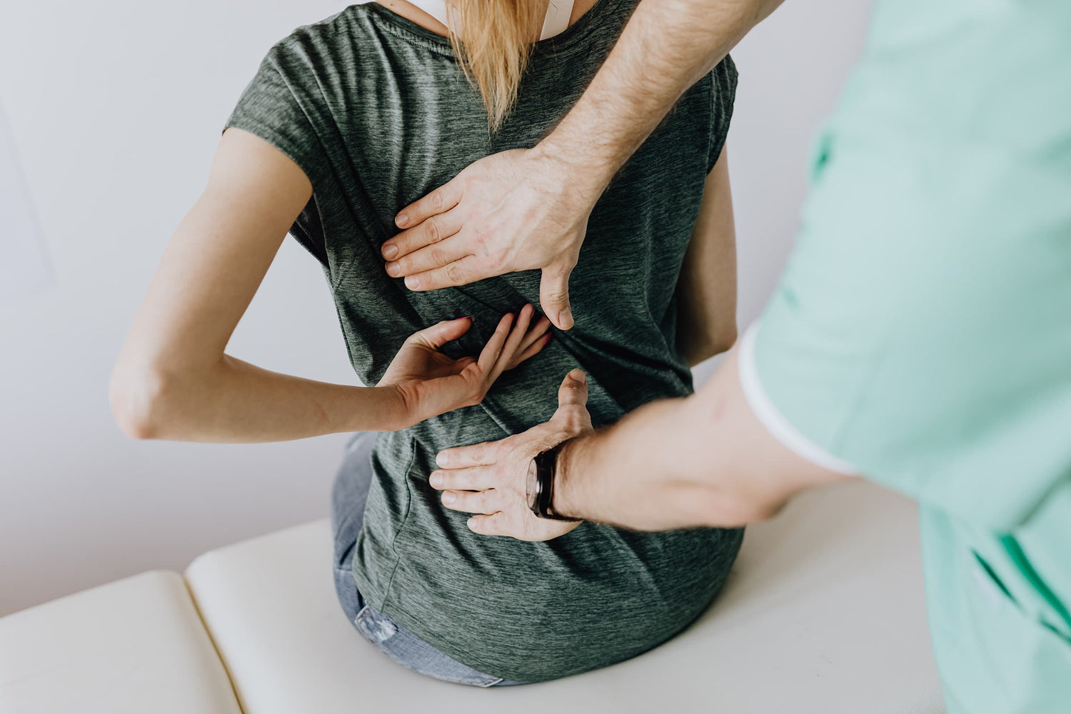 hands on a person's back providing relief from back pain treatment