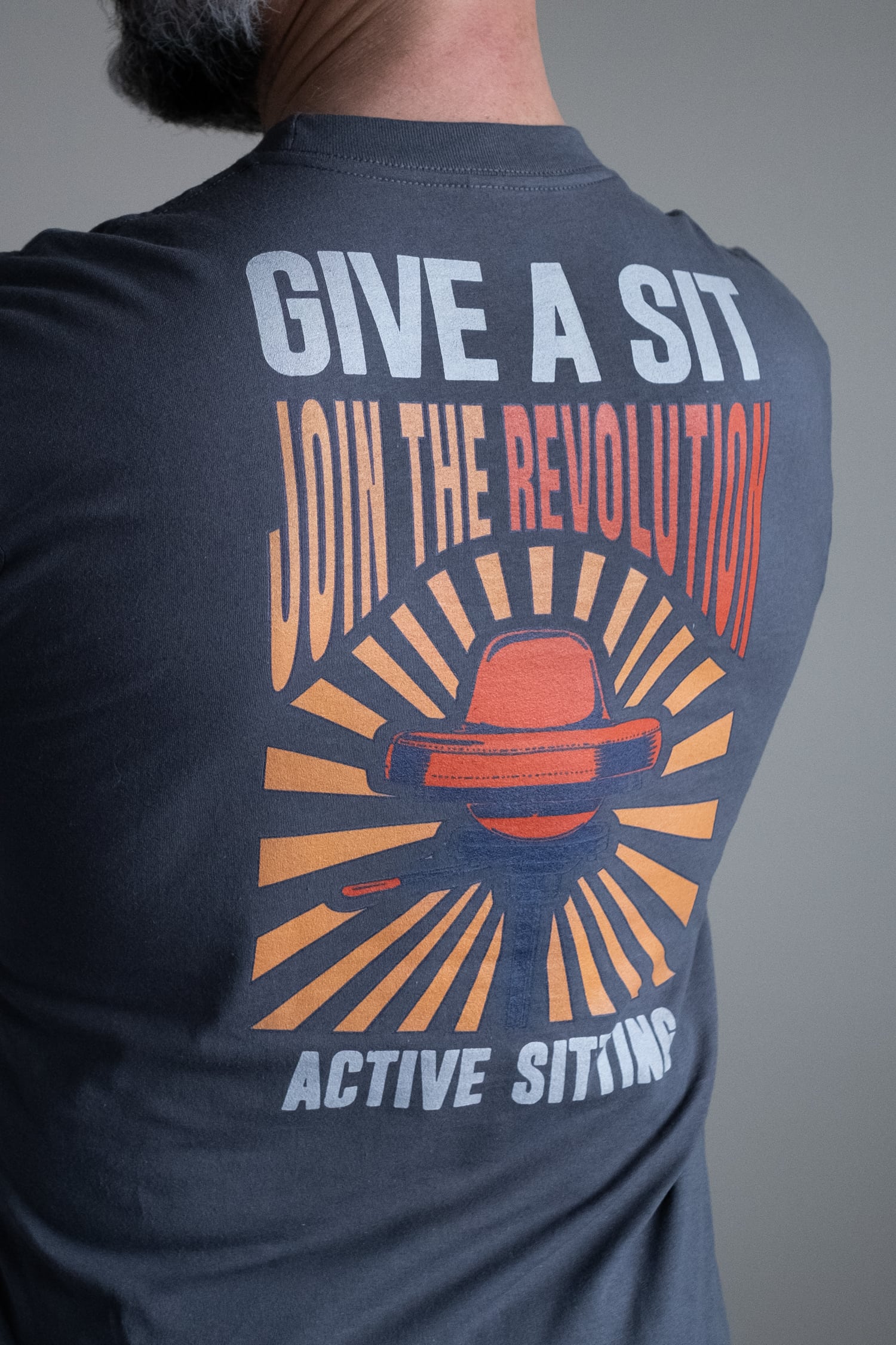 man wearing "give a sit" t-shirt